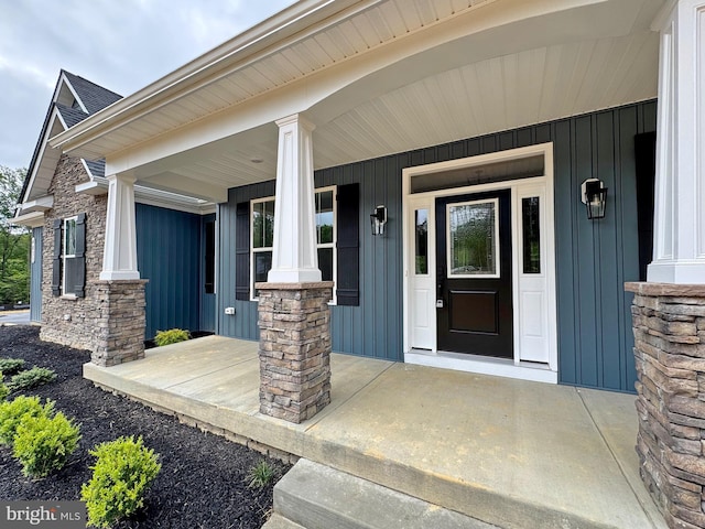 4035 Tamaron Ct, Brandywine, MD 20613 - view of exterior entry with board and batten siding, a porch, and stone siding