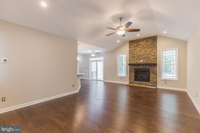 unfurnished living room with a fireplace, dark hardwood / wood-style flooring, ceiling fan, and a healthy amount of sunlight