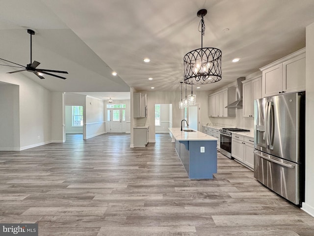 4035 Tamaron Ct, Brandywine, MD 20613 - kitchen with appliances with stainless steel finishes, a sink, wall chimney range hood, recessed lighting, and light wood-style flooring