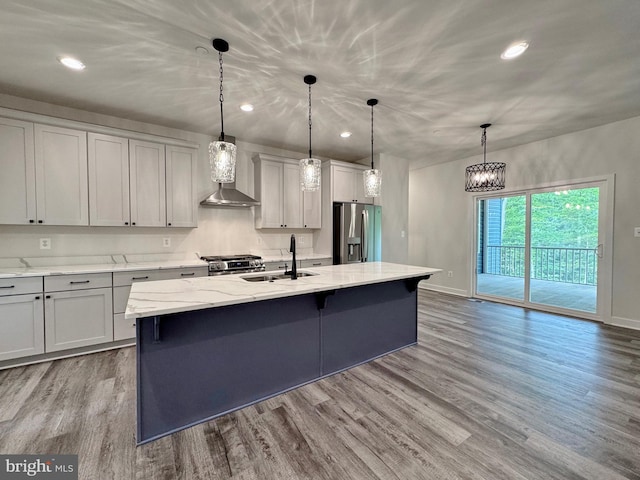 4035 Tamaron Ct, Brandywine, MD 20613 - kitchen featuring appliances with stainless steel finishes, a sink, wall chimney exhaust hood, wood finished floors, and baseboards