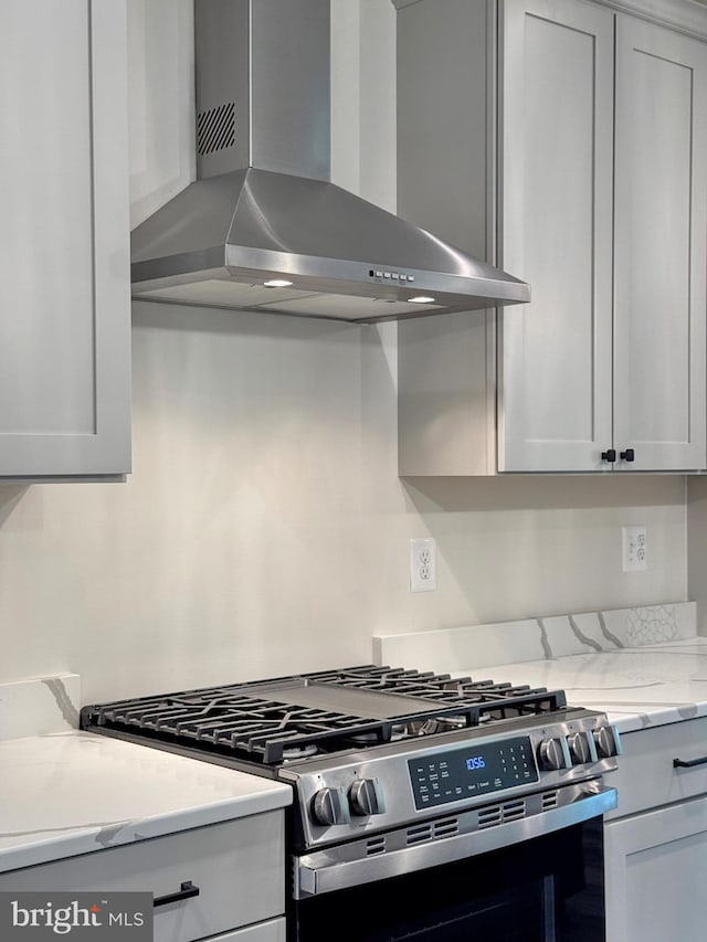 4035 Tamaron Ct, Brandywine, MD 20613 - kitchen featuring wall chimney exhaust hood, gas range, and light stone counters
