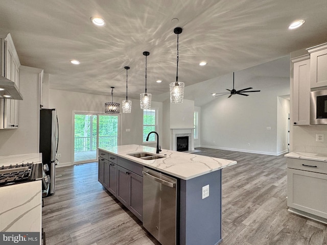 4035 Tamaron Ct, Brandywine, MD 20613 - kitchen featuring stainless steel appliances, a sink, baseboards, light wood-type flooring, and light stone countertops