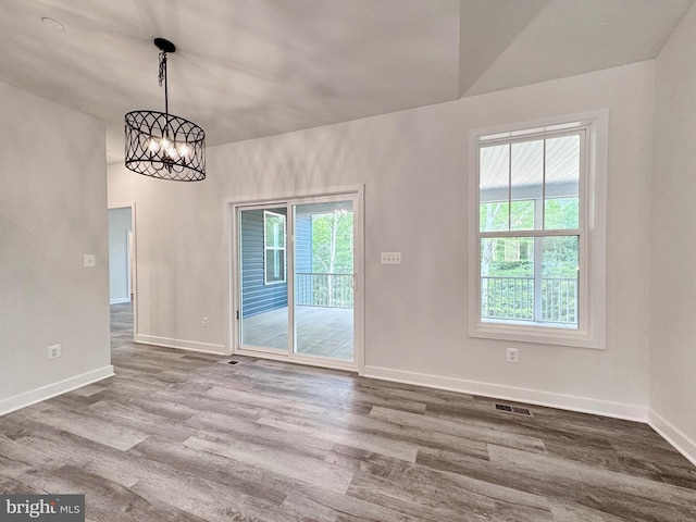4035 Tamaron Ct, Brandywine, MD 20613 - unfurnished dining area with a chandelier, wood finished floors, and baseboards