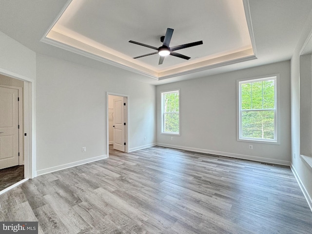 4035 Tamaron Ct, Brandywine, MD 20613 - unfurnished room featuring a tray ceiling, wood finished floors, a ceiling fan, and baseboards