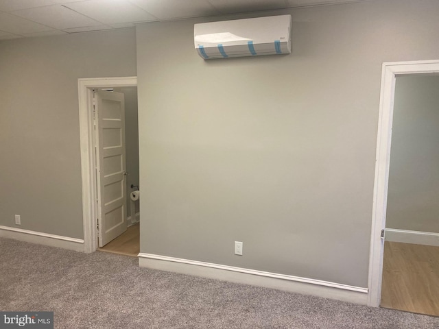 carpeted empty room with a paneled ceiling