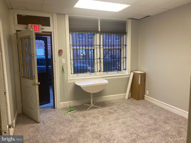 misc room with carpet flooring and a paneled ceiling