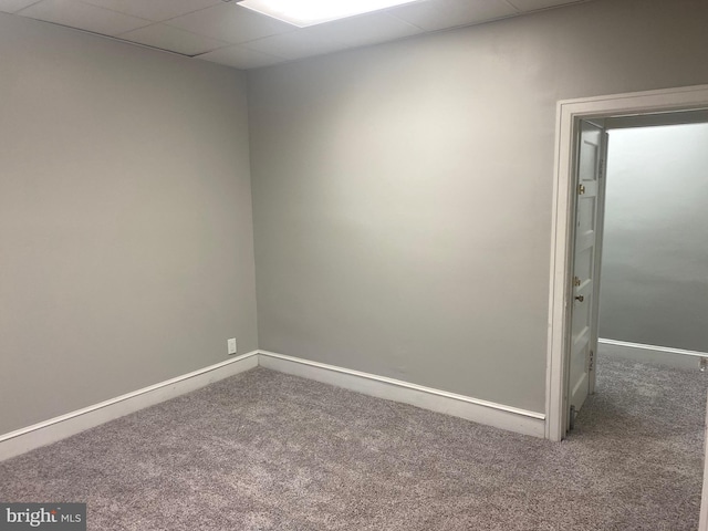 unfurnished room featuring a drop ceiling and carpet floors