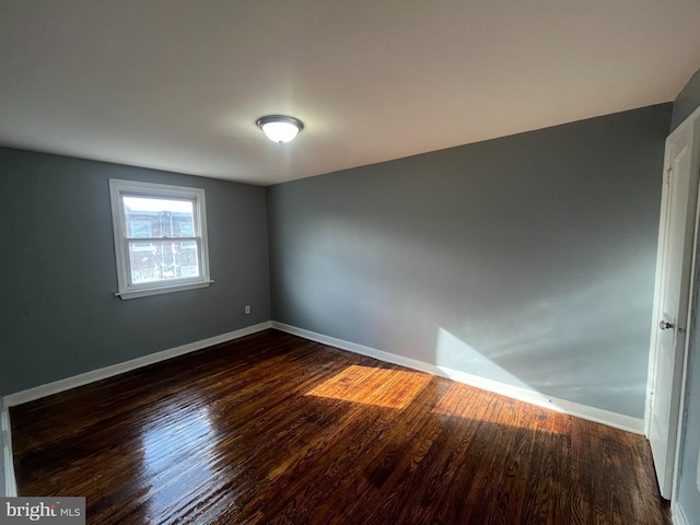 spare room featuring dark hardwood / wood-style floors