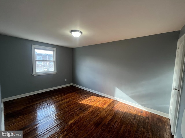 unfurnished room featuring dark hardwood / wood-style floors