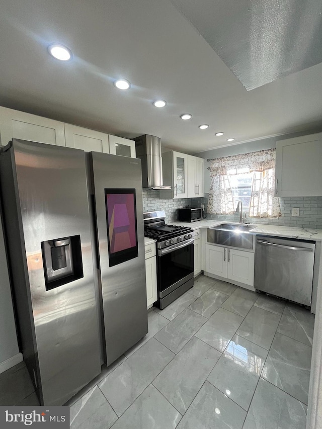 kitchen with decorative backsplash, stainless steel appliances, white cabinetry, and sink