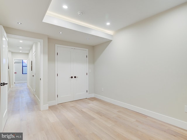 unfurnished bedroom featuring light hardwood / wood-style floors and a closet