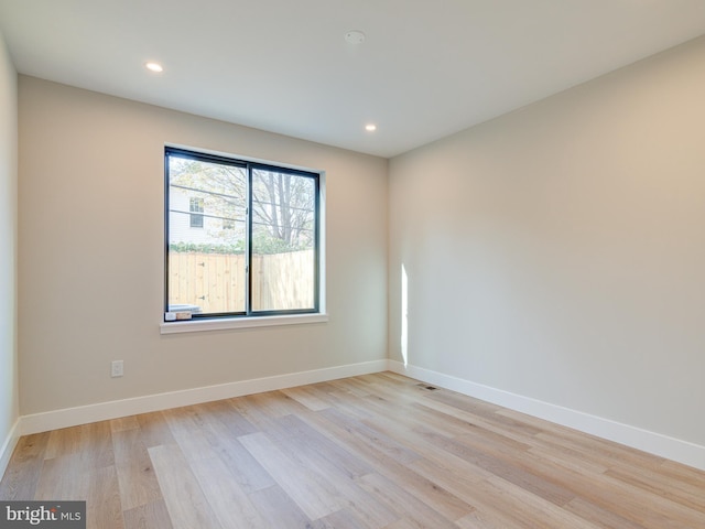 empty room with light hardwood / wood-style flooring