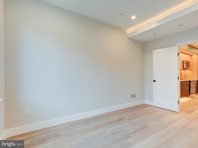 empty room with light hardwood / wood-style floors