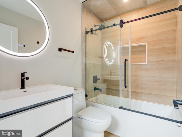 full bathroom featuring vanity, toilet, and bath / shower combo with glass door