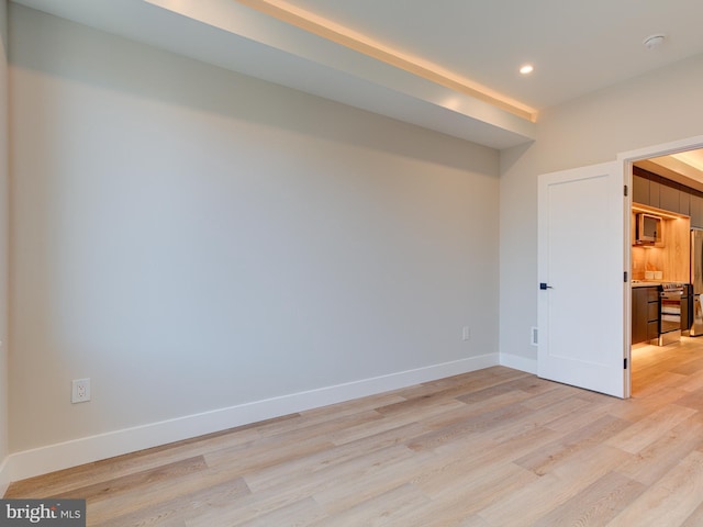 spare room featuring light hardwood / wood-style flooring