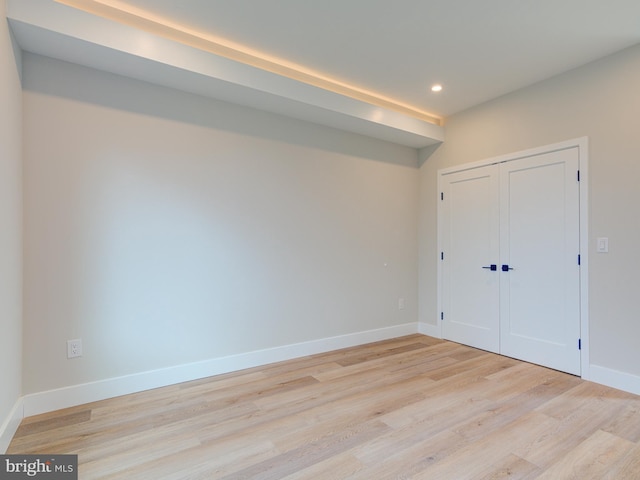 interior space with a closet and light hardwood / wood-style floors