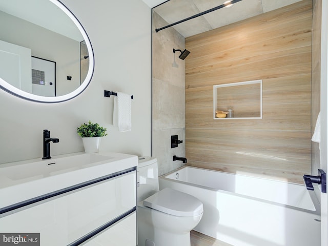 full bathroom featuring vanity, toilet, and tiled shower / bath