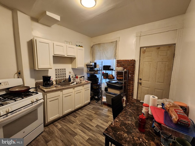 kitchen featuring white cabinets, white gas stove, dark hardwood / wood-style floors, and sink