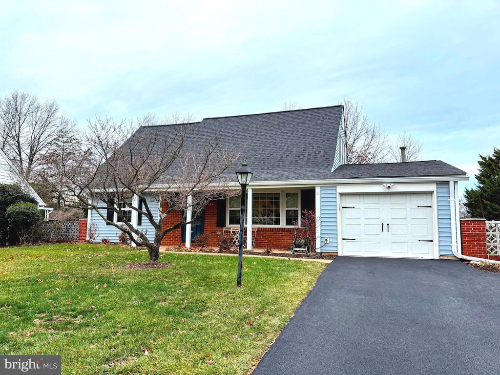 view of front of house with a front lawn and a garage