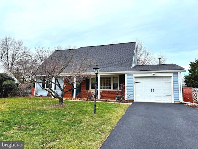 view of front of property with a garage and a front lawn