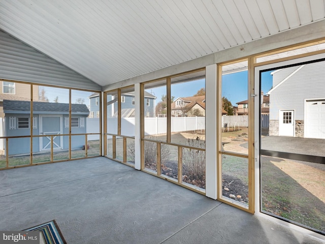 unfurnished sunroom featuring lofted ceiling