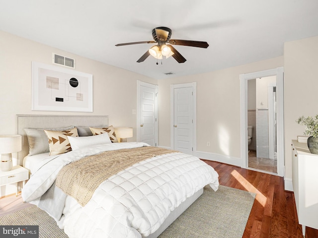 bedroom featuring ceiling fan, dark hardwood / wood-style floors, and ensuite bath