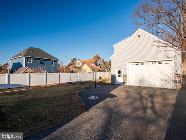 view of side of property featuring a yard and a garage