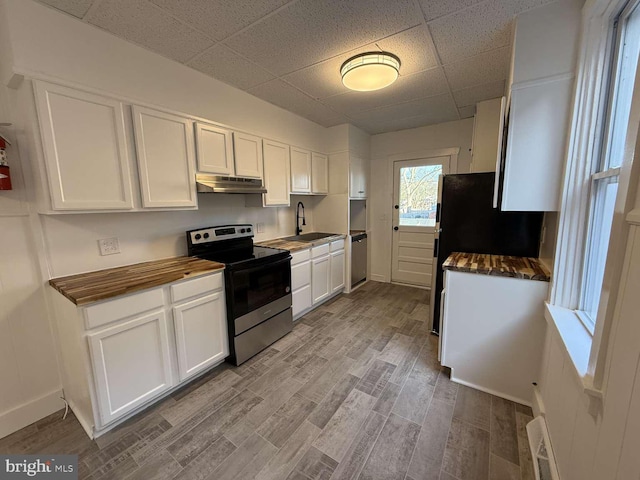 kitchen featuring sink, white cabinets, stainless steel appliances, and light hardwood / wood-style flooring