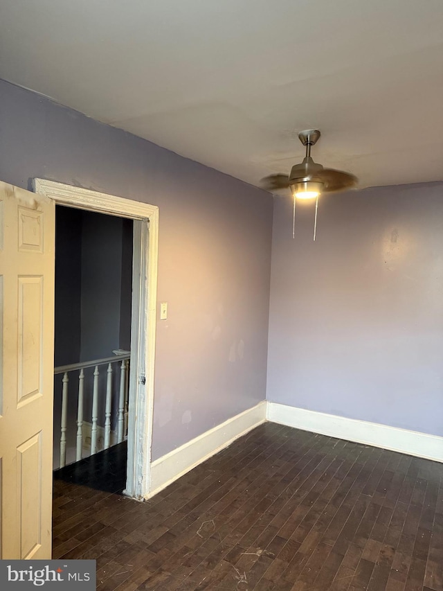 unfurnished room with ceiling fan and dark hardwood / wood-style floors