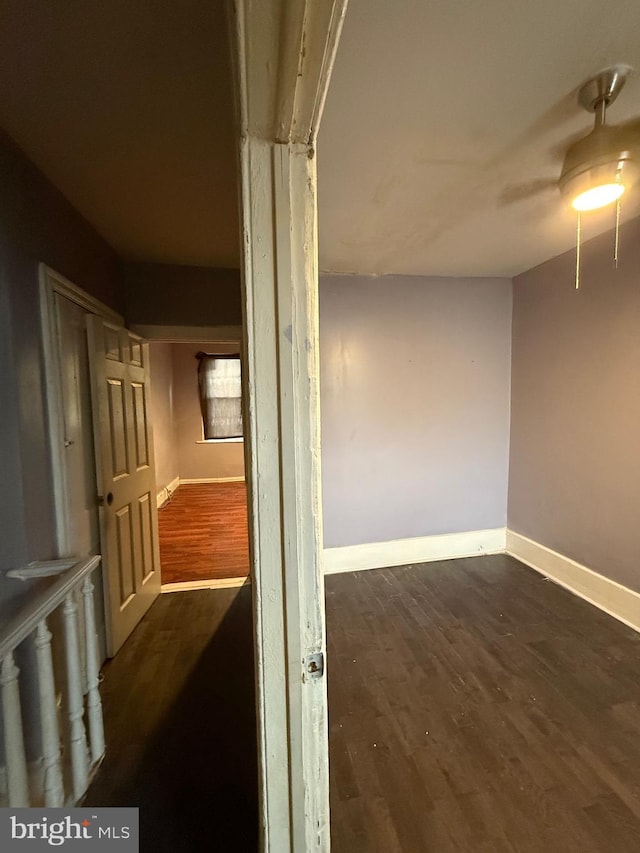 hallway with dark hardwood / wood-style floors