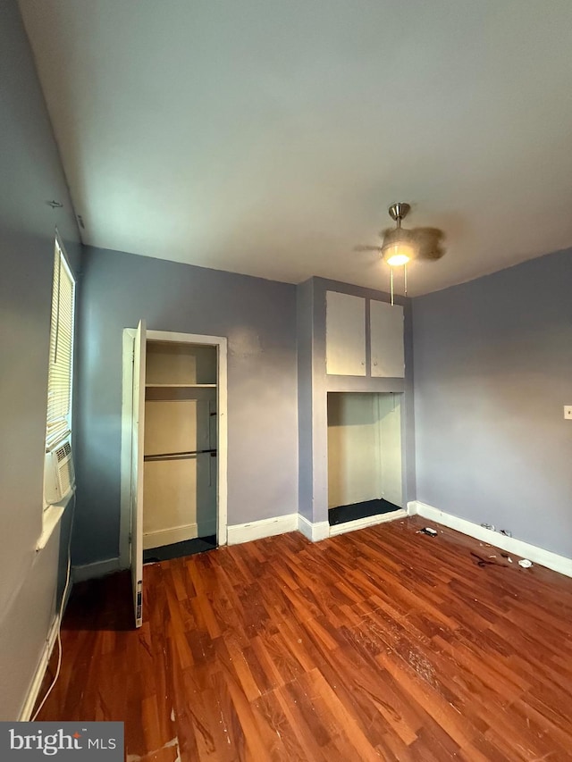 unfurnished bedroom featuring ceiling fan and wood-type flooring