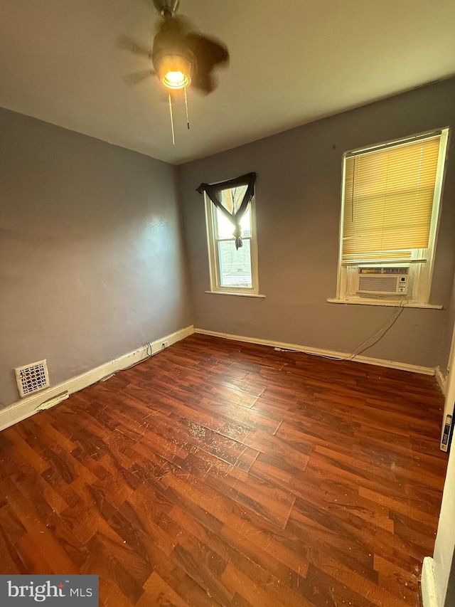 unfurnished room featuring hardwood / wood-style flooring and cooling unit