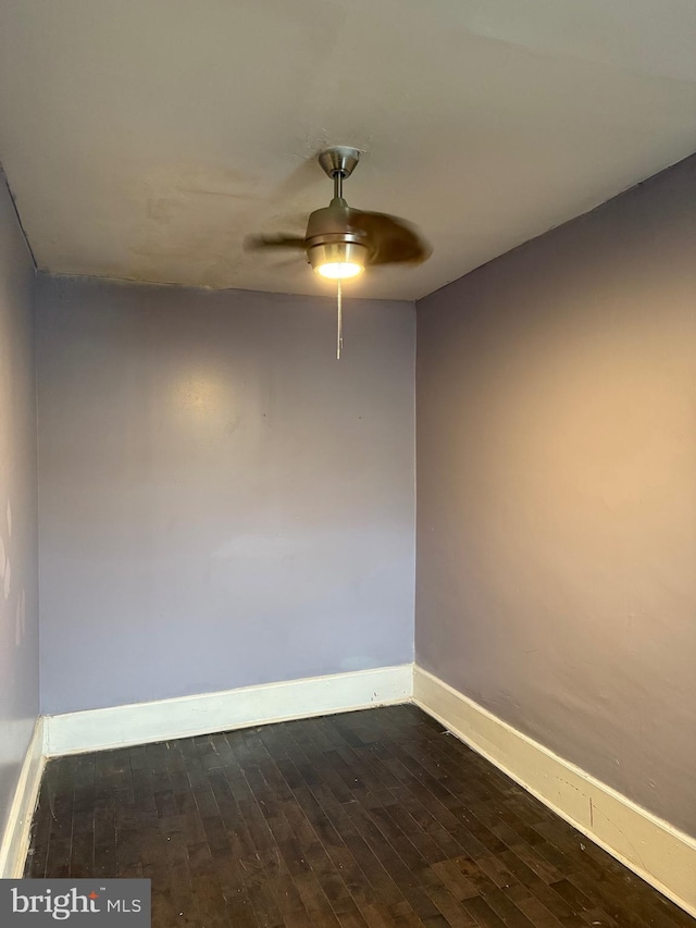 spare room featuring ceiling fan and dark hardwood / wood-style floors