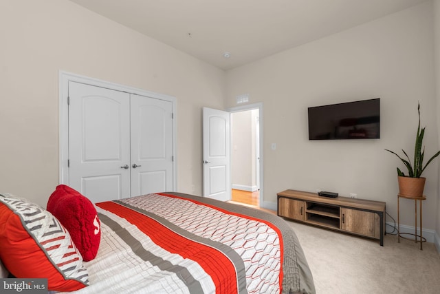 bedroom with carpet and a closet