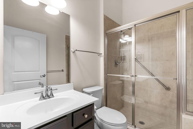 bathroom featuring vanity, toilet, and walk in shower