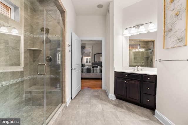 bathroom featuring tile patterned floors, vanity, and a shower with door