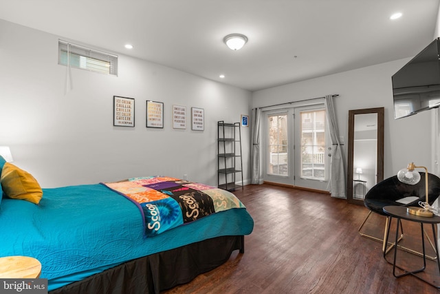 bedroom featuring dark hardwood / wood-style flooring and access to outside