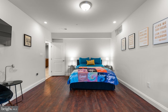 bedroom with dark hardwood / wood-style flooring