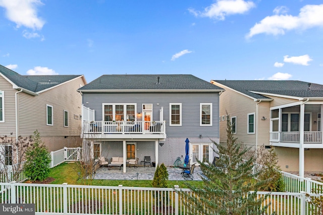 back of property with a patio area, a balcony, and an outdoor hangout area