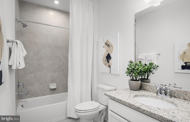 full bathroom featuring shower / bath combination with curtain, vanity, and toilet