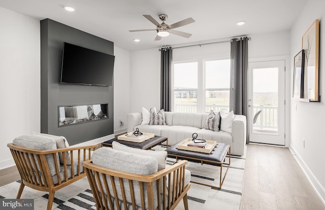 living room featuring ceiling fan and light wood-type flooring