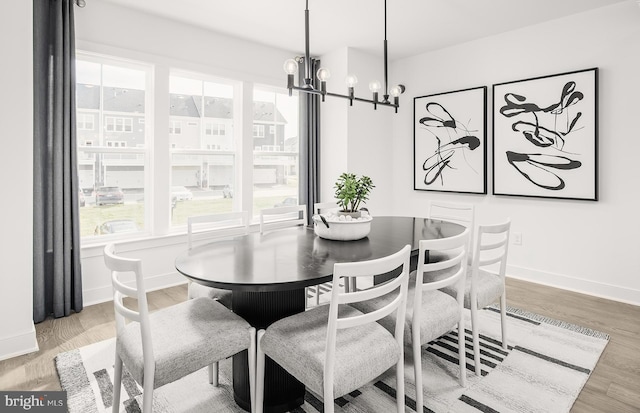 dining room featuring hardwood / wood-style flooring and a chandelier