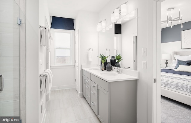 bathroom with tile patterned flooring, vanity, and an enclosed shower