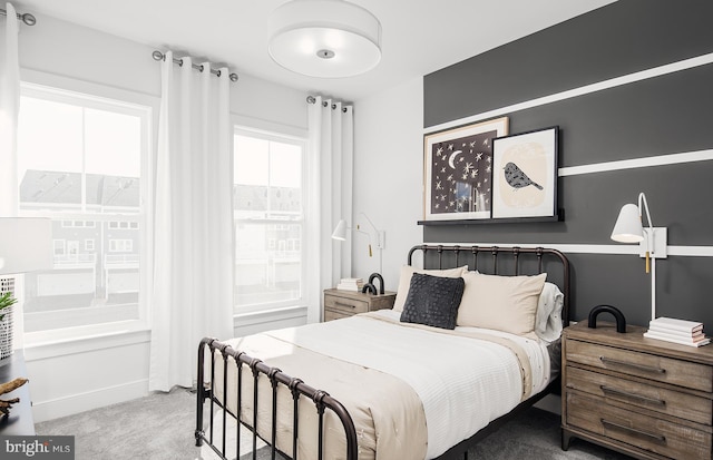 carpeted bedroom featuring multiple windows