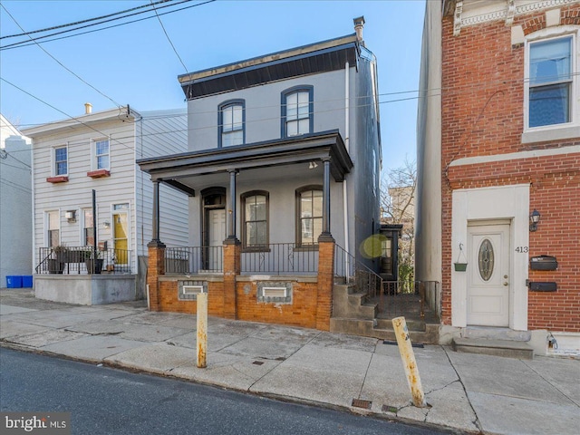 townhome / multi-family property featuring a porch