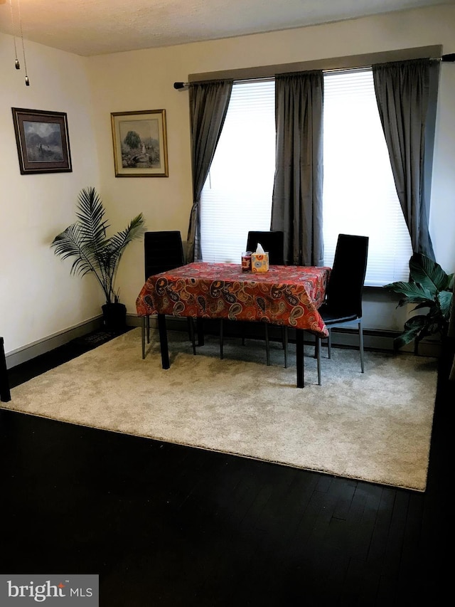 dining space featuring wood-type flooring