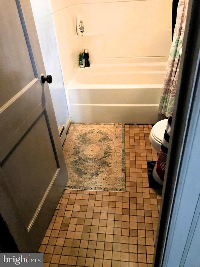 bathroom with tile patterned flooring, toilet, a bath, and a baseboard radiator