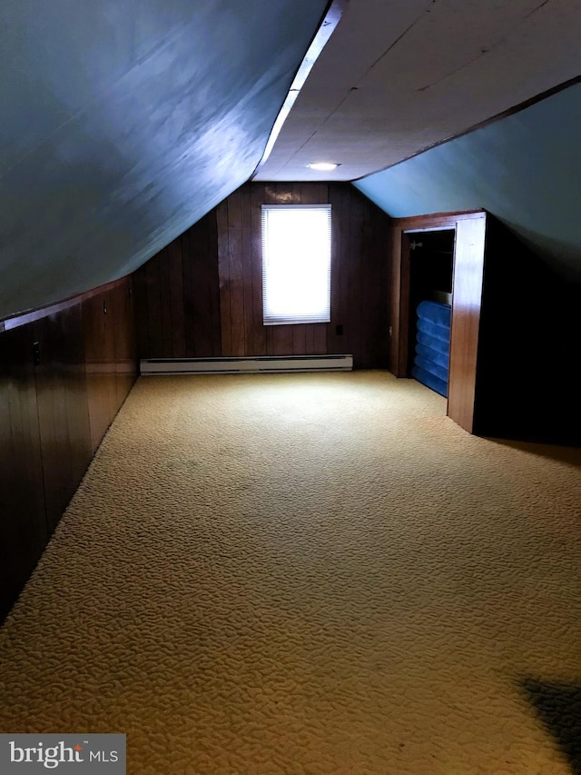 bonus room with light carpet, wooden walls, a baseboard radiator, and vaulted ceiling