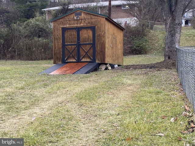 view of outbuilding featuring a lawn