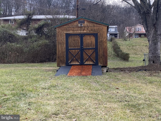 view of outdoor structure featuring a lawn